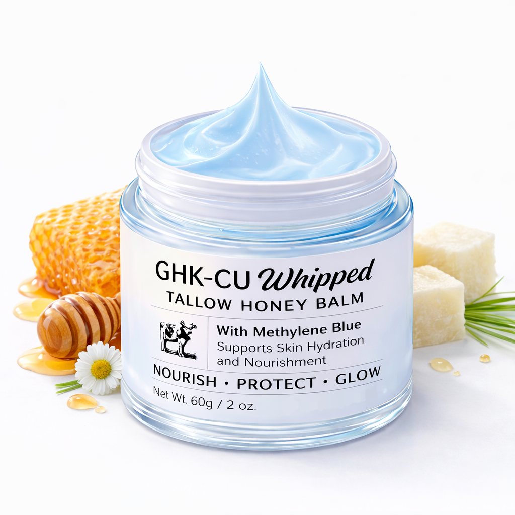 Jar of GHK-CU Whipped Tallow Honey Balm with honeycomb, honey, and soap in the background